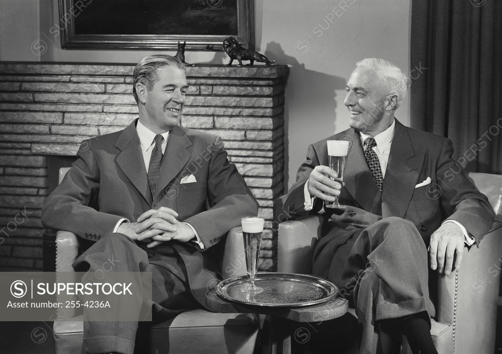 Stock Photo: 255-4236A Close-up of two mature men sitting together and drinking beer