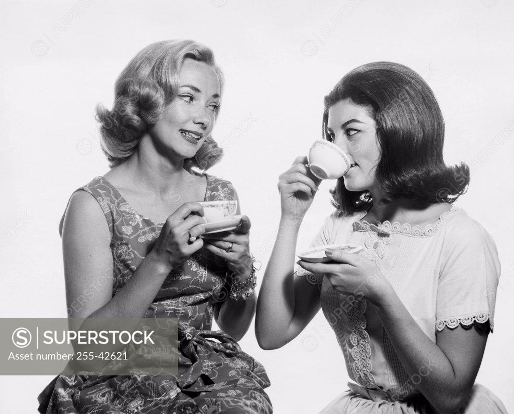 Stock Photo: 255-42621 Close-up of two young women having tea