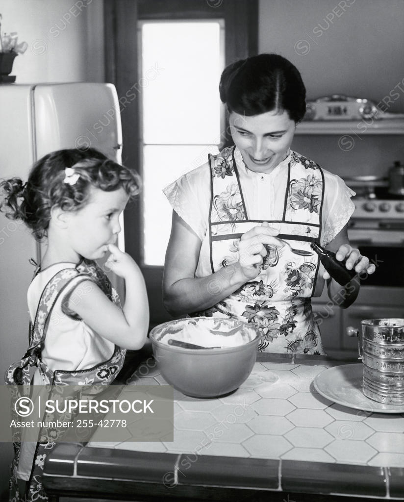 Stock Photo: 255-42778 Mid adult woman and her daughter preparing food in a kitchen