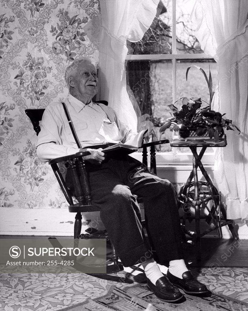 Stock Photo: 255-4285 Senior man sitting in rocking chair