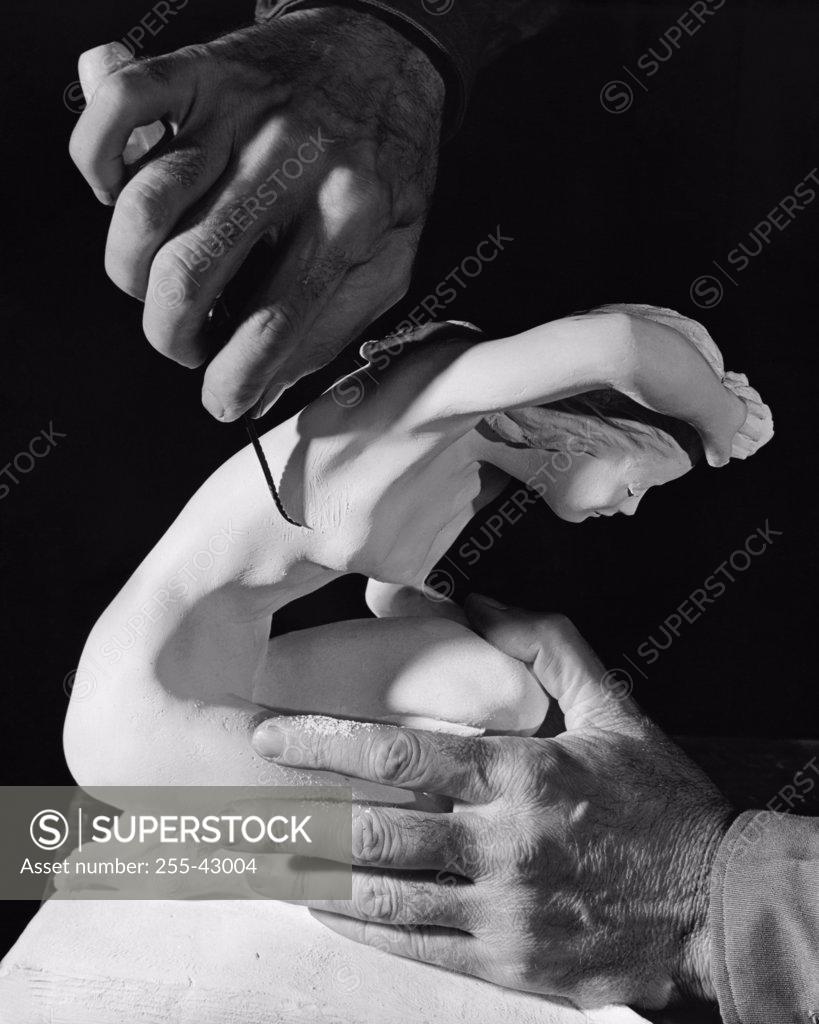 Stock Photo: 255-43004 Close-up of a person's hands carving a statue