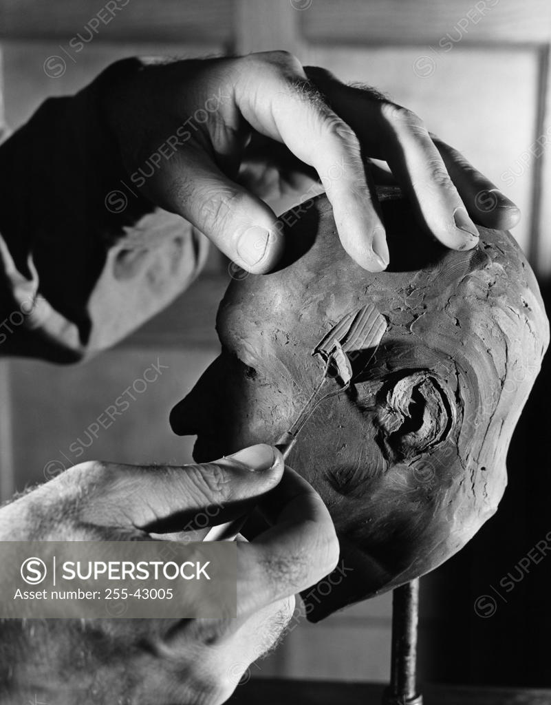 Stock Photo: 255-43005 Close-up of a person's hands molding a clay sculpture