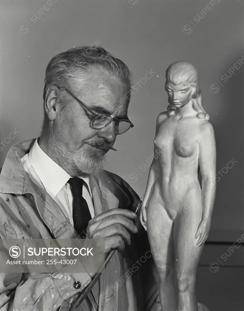 Close-up of a senior man carving a statue