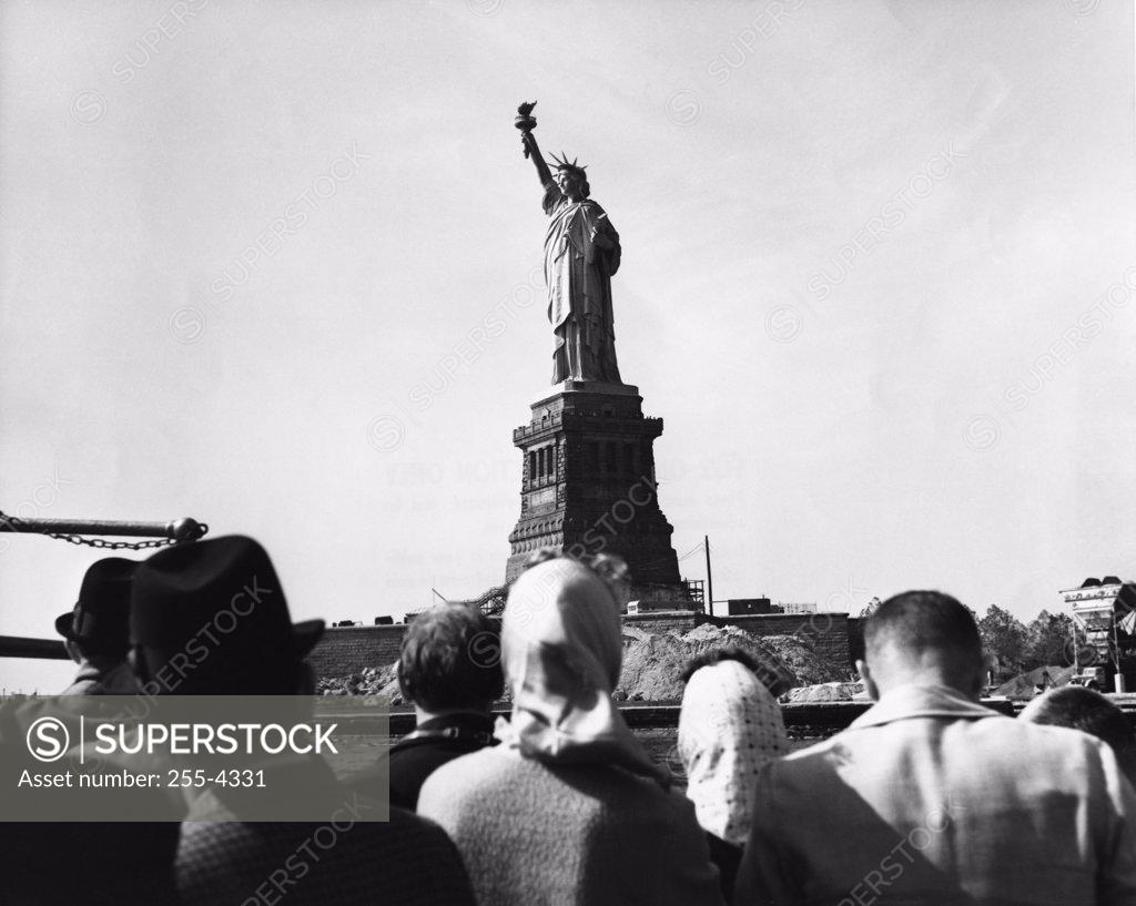 Stock Photo: 255-4331 Tourists looking at a statue, Statue of Liberty, New York City, New York, USA
