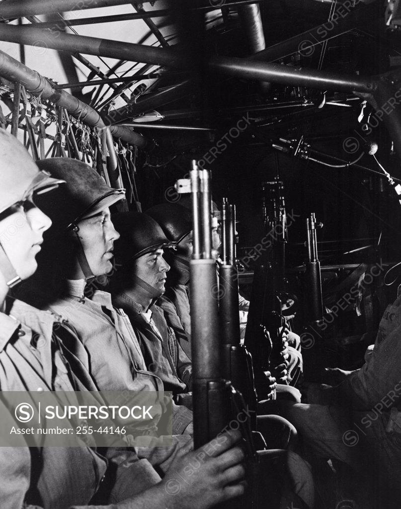 Stock Photo: 255-44146 Group of US Marines sitting with weapons in helicopter