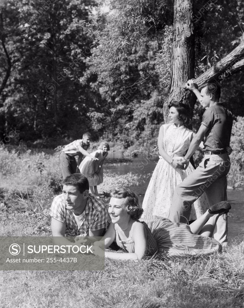 Stock Photo: 255-4437B Three teenage couples at the riverside
