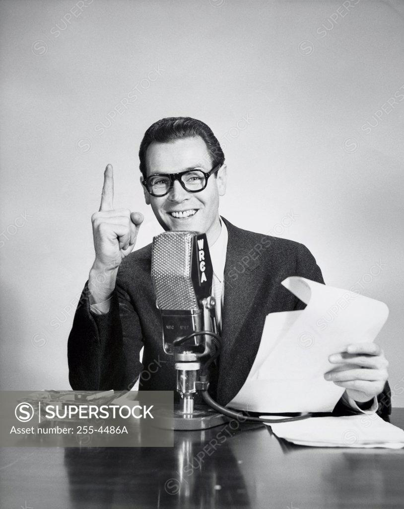 Stock Photo: 255-4486A Portrait of a reporter speaking into a microphone in a radio broadcast studio