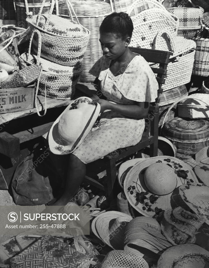 Stock Photo: 255-47888 Jamaica, Kingston, woman decorating straw hat