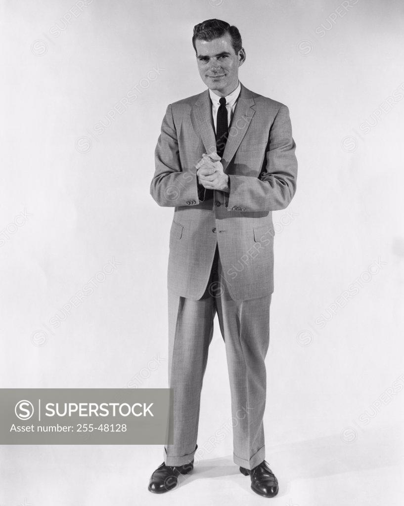 Stock Photo: 255-48128 Studio portrait of businessman with hands clasped