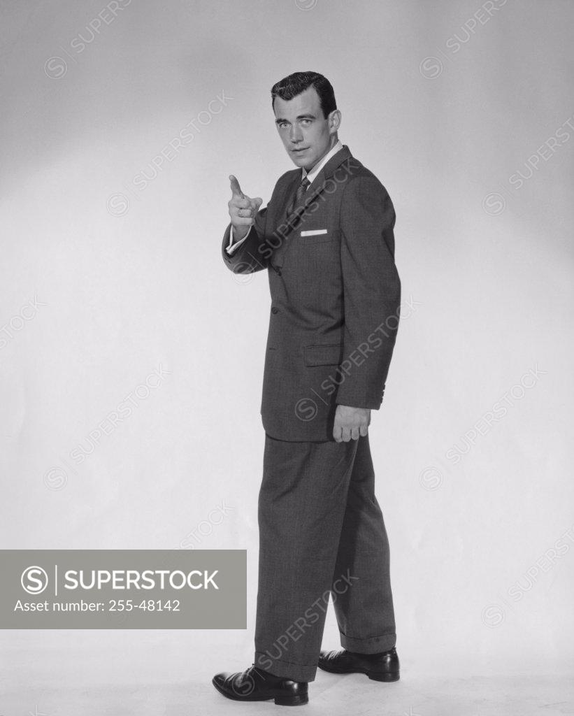 Stock Photo: 255-48142 Side profile of businessman pointing forward