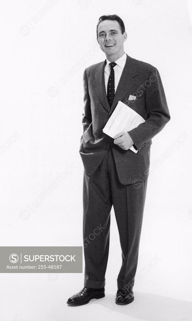 Stock Photo: 255-48187 Portrait of a businessman standing with his hand in his pocket