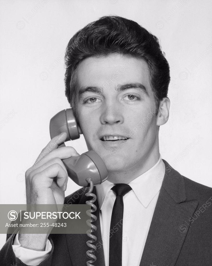 Stock Photo: 255-48243 Young businessman using telephone