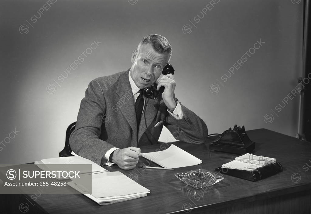 Stock Photo: 255-48258 Mature businessman arguing on telephone