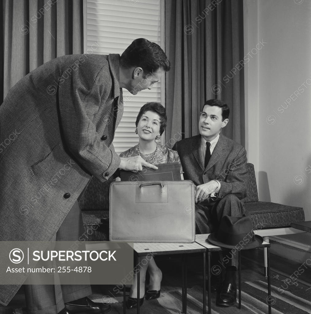 Stock Photo: 255-4878 Side profile of salesman talking to young couple