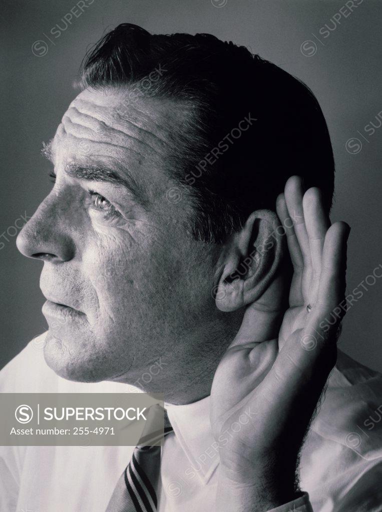 Stock Photo: 255-4971 Close-up of a mature man with a cupped hand to his ear