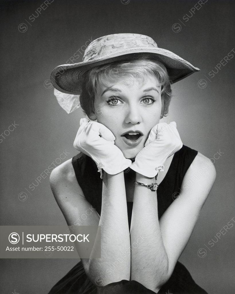 Stock Photo: 255-50022 Portrait of a young woman with her hands on her chin