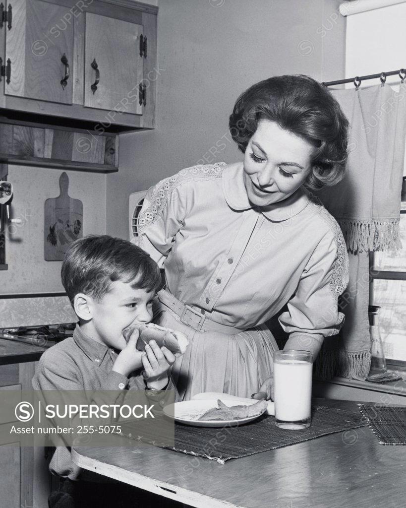 Stock Photo: 255-5075 Close-up of a mother watching her son eat his breakfast