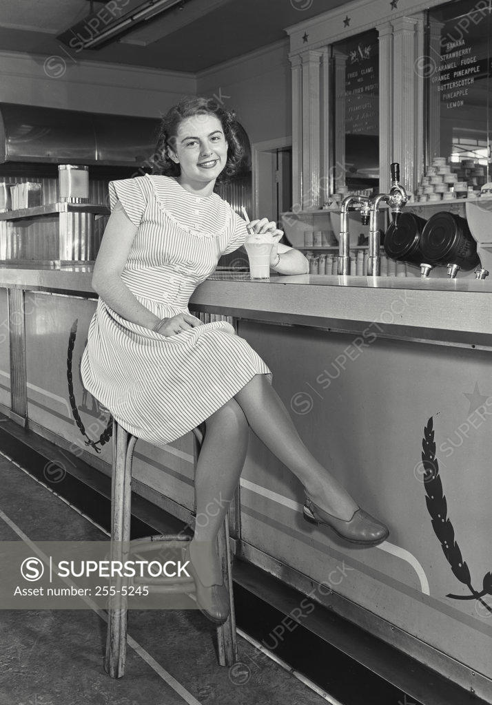 Stock Photo: 255-5245 Portrait of a teenage girl sitting in a cafe and smiling, 1947
