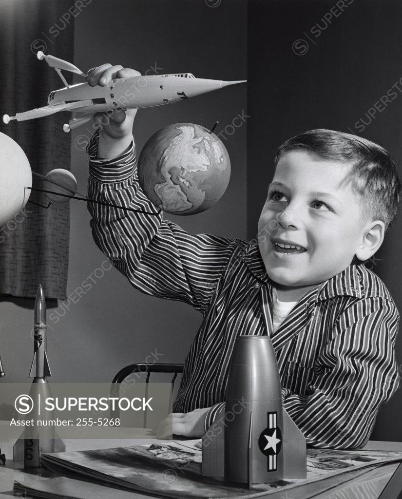 Stock Photo: 255-5268 Close-up of a boy playing with a model of a rocket
