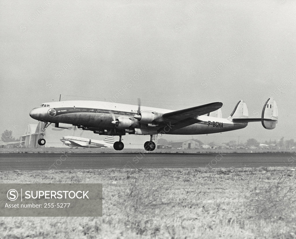 Stock Photo: 255-5277 Low angle view of an airplane taking off, Lockheed Constellation