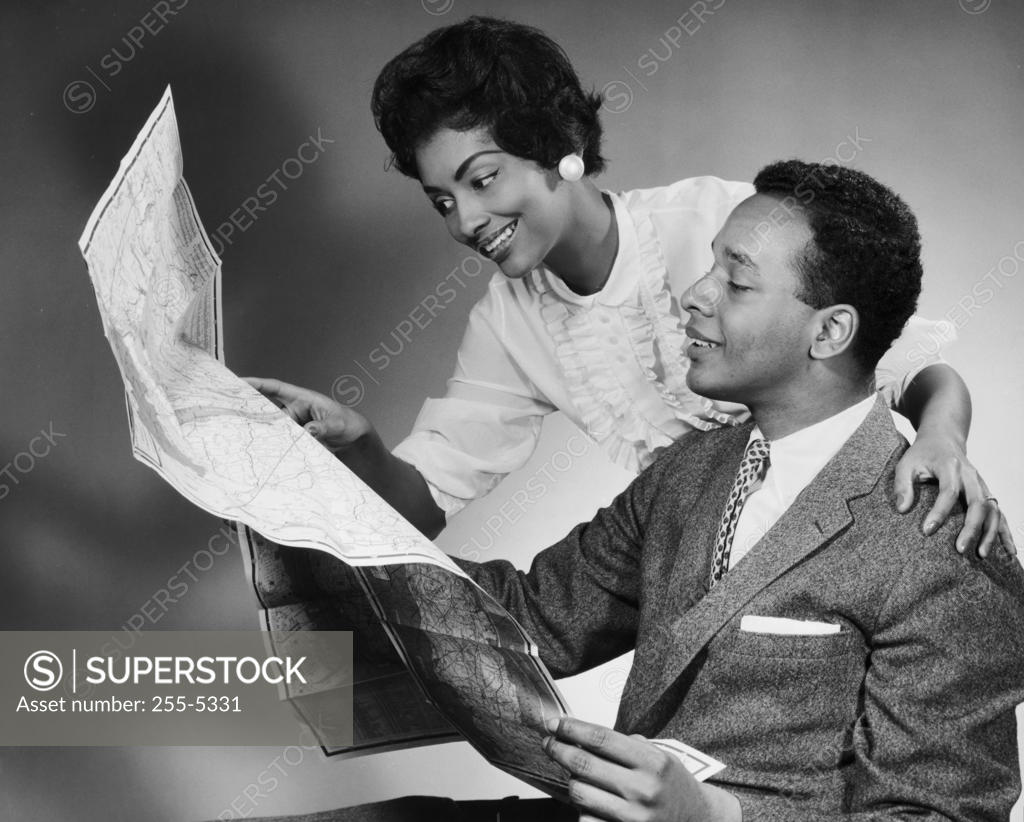 Stock Photo: 255-5331 Side profile of a young couple reading a map