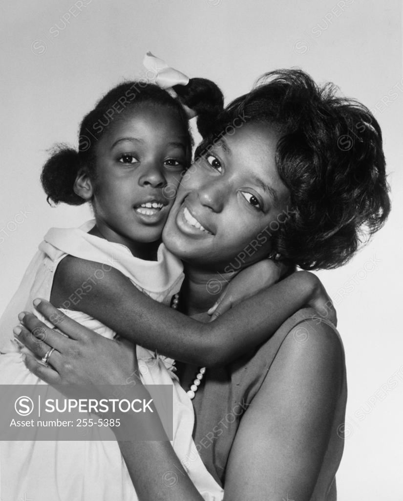 Stock Photo: 255-5385 Mother hugging little daughter