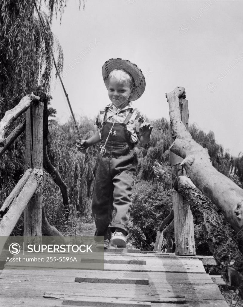 Stock Photo: 255-5596A Low angle view of boy walking on footbridge