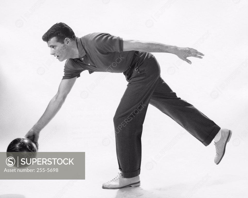 Stock Photo: 255-5698 Young adult man rolling a bowling ball