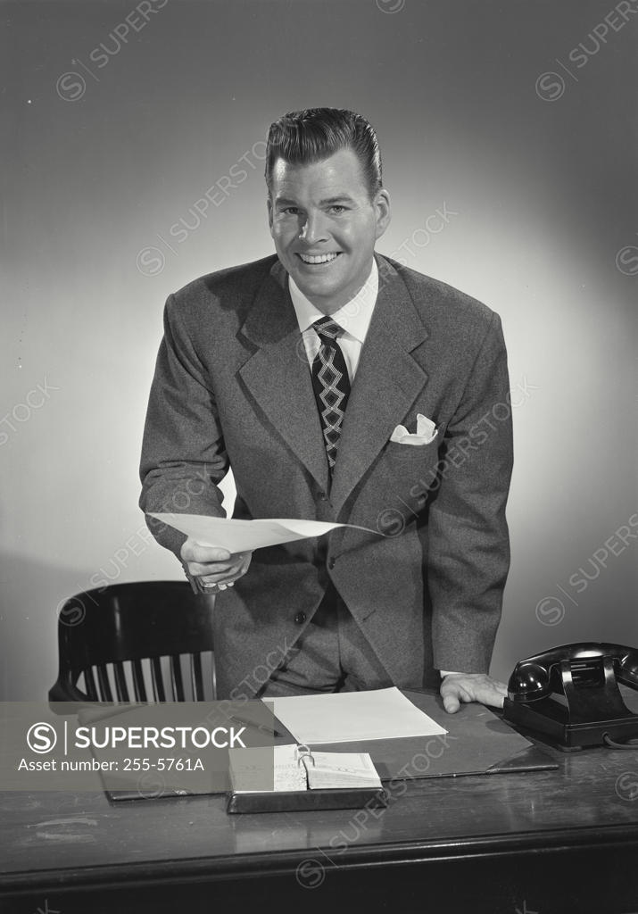 Stock Photo: 255-5761A Businessman holding a document and smiling