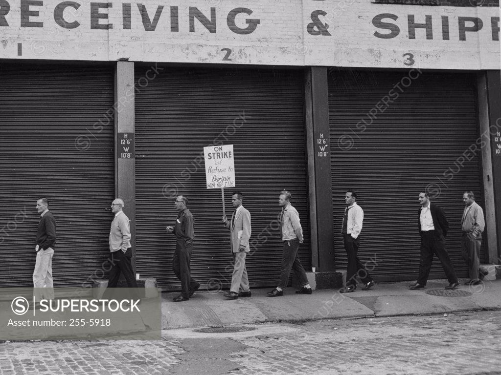 Stock Photo: 255-5918 Group protesting, holding signs in front of building