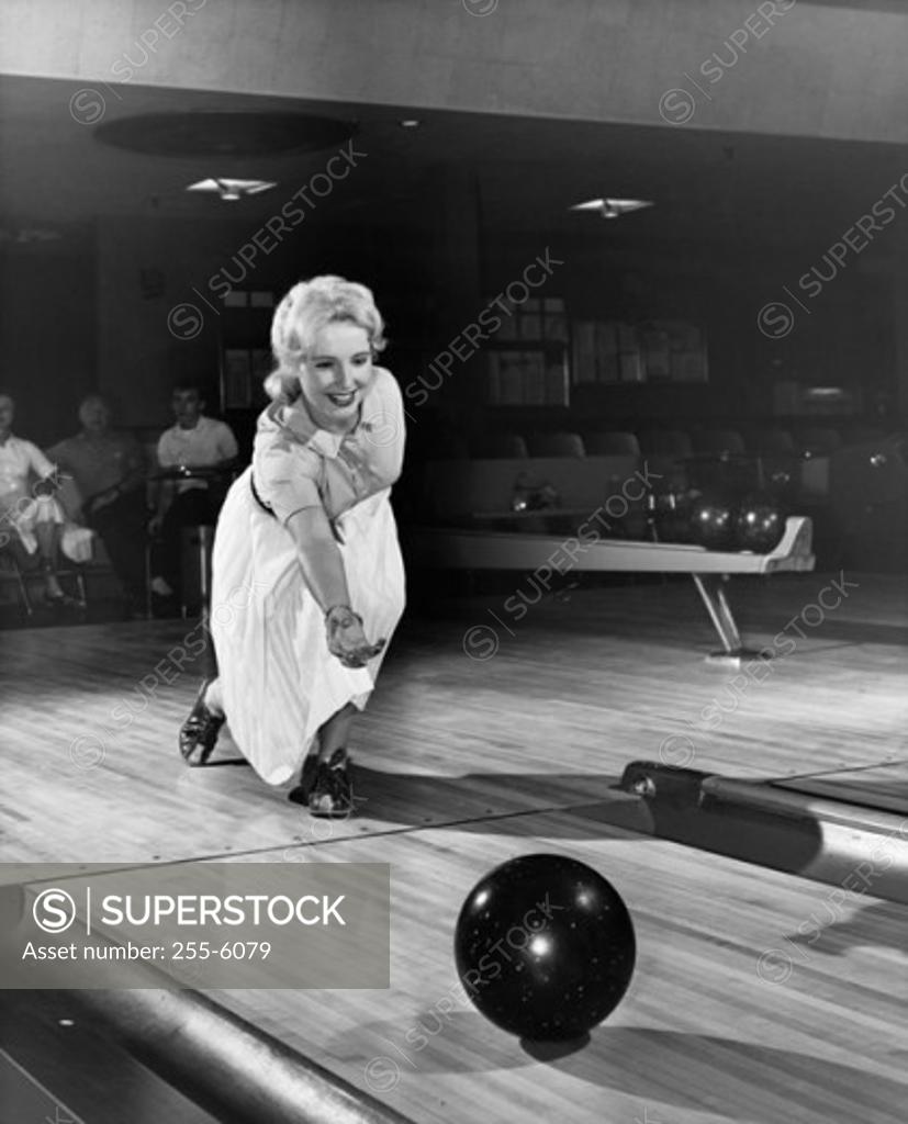 Stock Photo: 255-6079 Young adult woman bowling