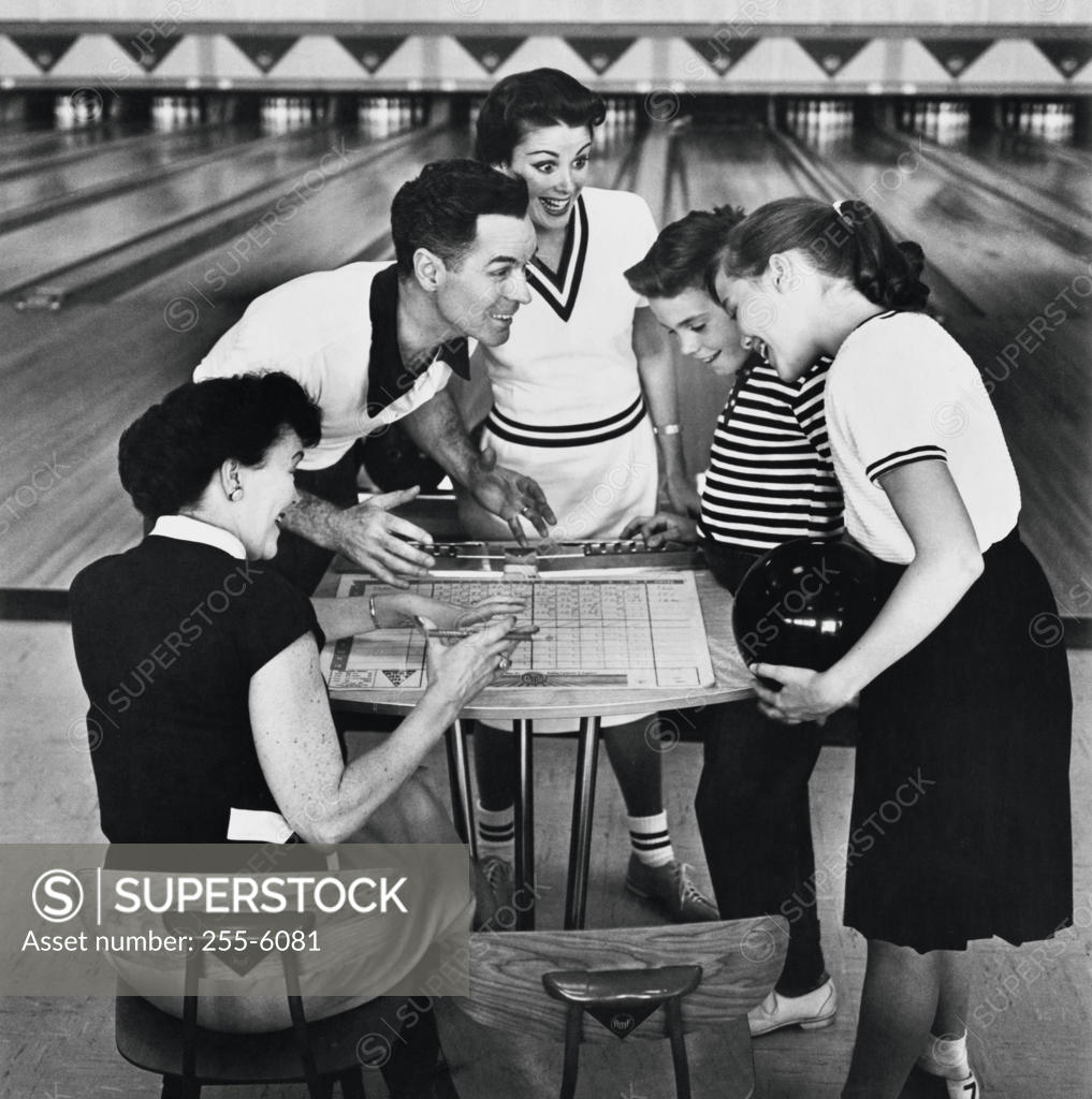 Stock Photo: 255-6081 Family checking scores while bowling