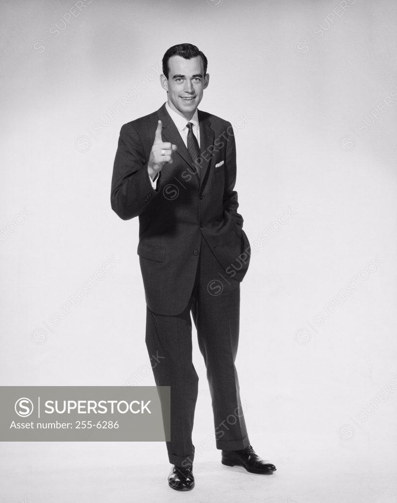Stock Photo: 255-6286 Portrait of businessman pointing upwards