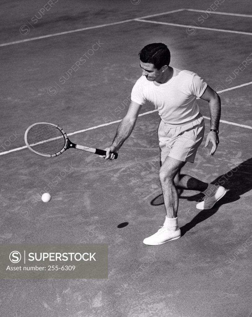 Stock Photo: 255-6309 High angle view of a young man playing tennis on a tennis court