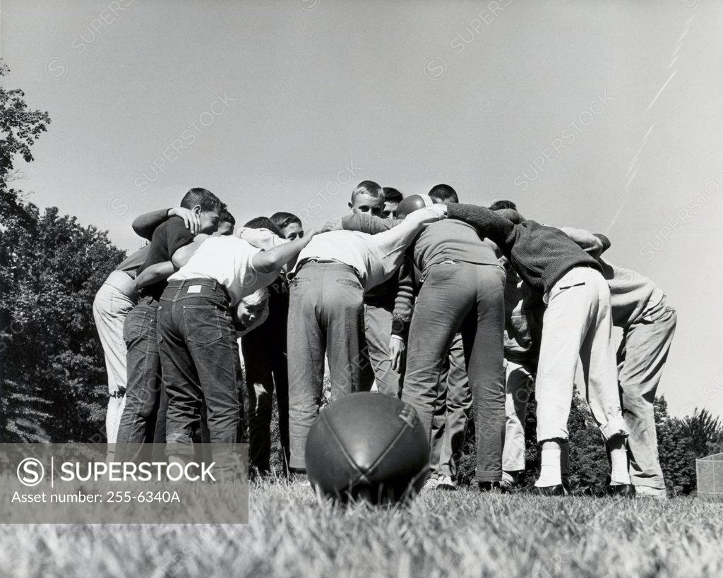 Stock Photo: 255-6340A Group of boys standing in a huddle