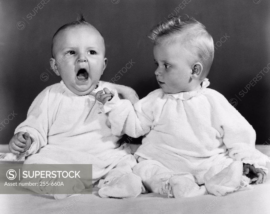 Stock Photo: 255-660A Close-up of two babies sitting together