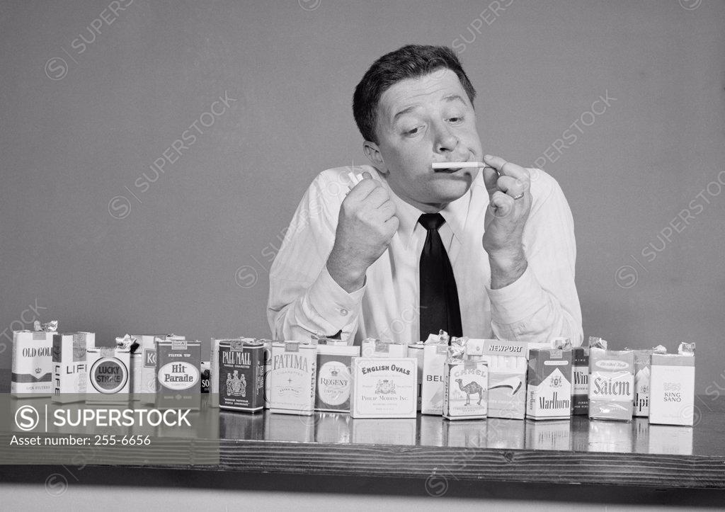 Stock Photo: 255-6656 Mid adult man smelling a cigarette