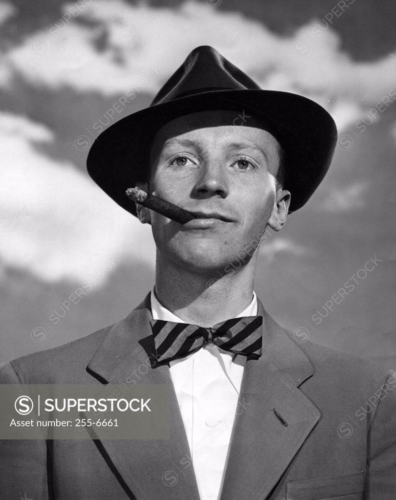 Stock Photo: 255-6661 Close-up of a businessman smoking a cigar