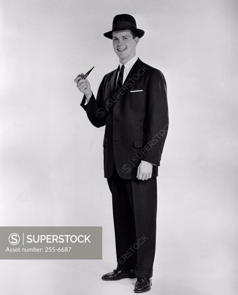 Stock Photo: 255-6687 Studio portrait of smiling man with pipe