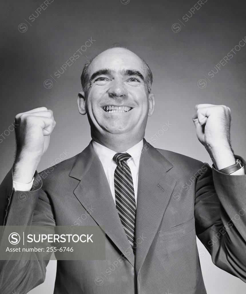 Stock Photo: 255-6746 Close-up of a businessman smiling with his fists clenched