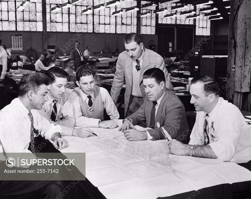 Stock Photo: 255-7142 Business executives looking at a blueprint
