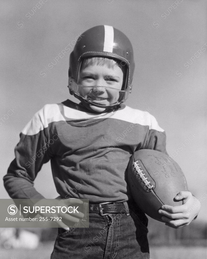 Stock Photo: 255-7292 Portrait of boy holding american football