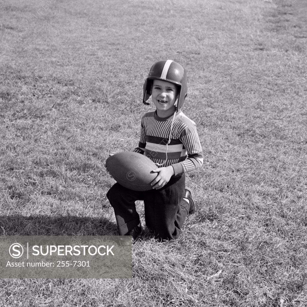 Stock Photo: 255-7301 Portrait of a boy holding a football