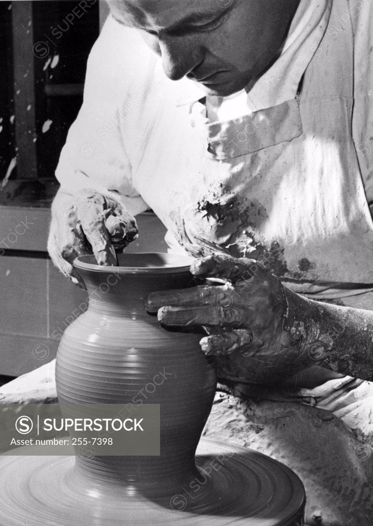 Stock Photo: 255-7398 Potter working on a pottery wheel