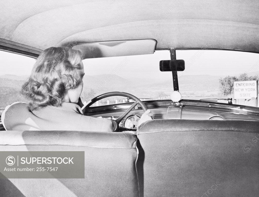 Stock Photo: 255-7547 Rear view of a woman driving a car