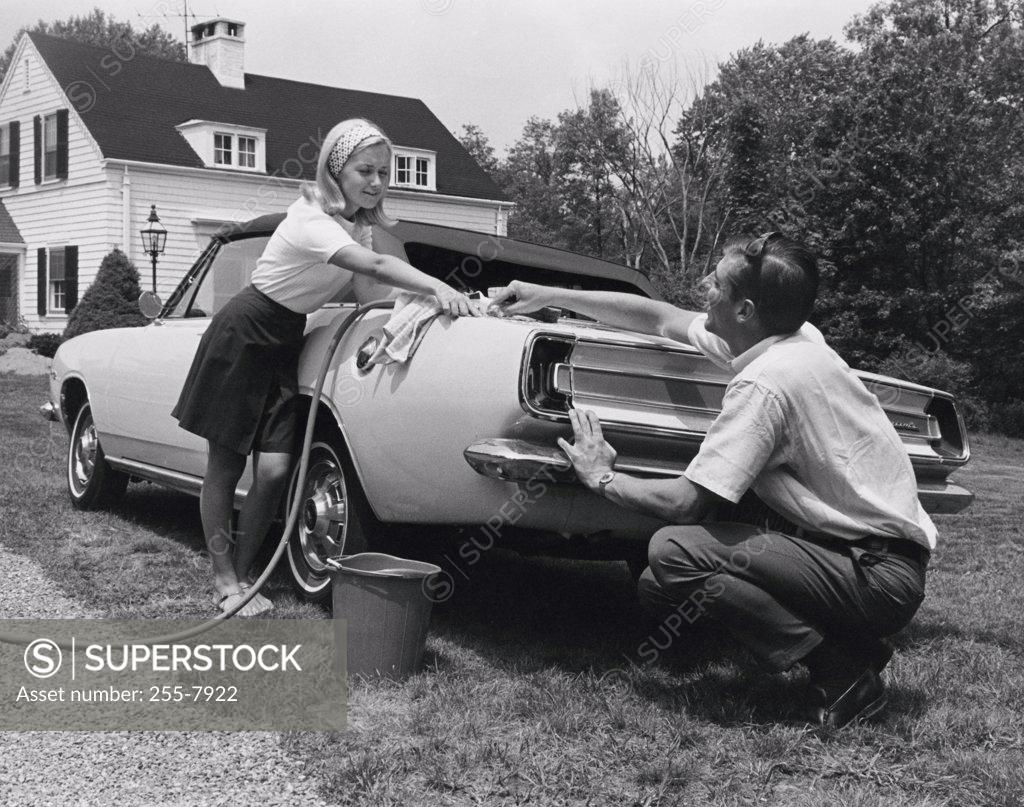 Stock Photo: 255-7922 Low angle view of a mid adult couple washing a car