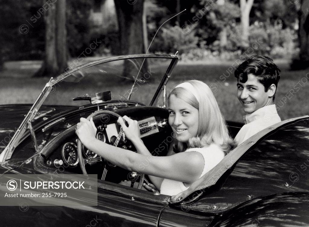 Stock Photo: 255-7925 Portrait of a young couple sitting in a convertible car