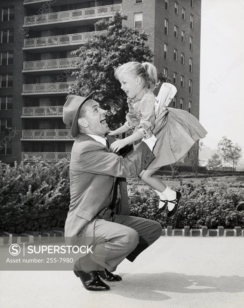 Stock Photo: 255-7980 Side profile of a father picking up his daughter