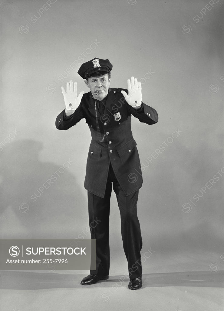 Stock Photo: 255-7996 Police officer making a stop gesture