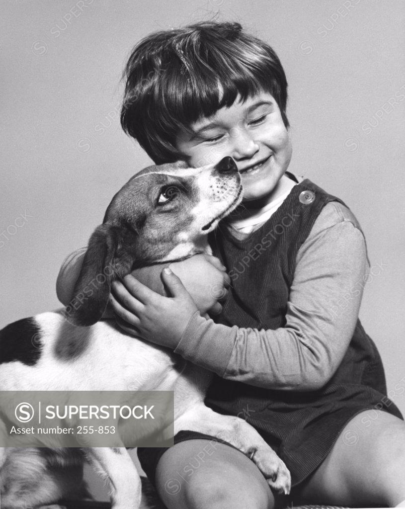 Stock Photo: 255-853 Portrait of girl hugging dog